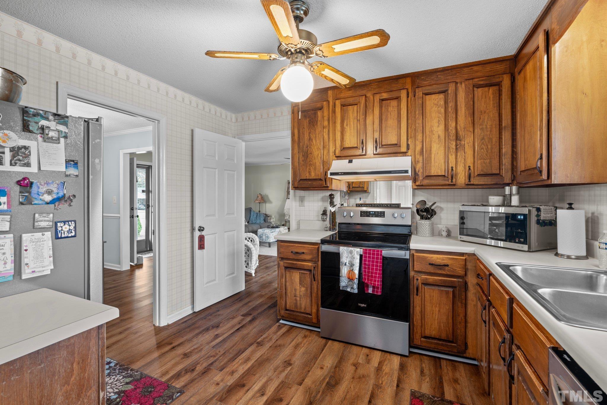 107 Murchison Drive Dunn, NC 28334 - Photo 10 of 37 a kitchen with stainless steel appliances granite countertop a stove and a sink