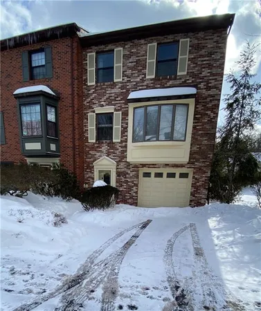 a view of a house with a yard and garage