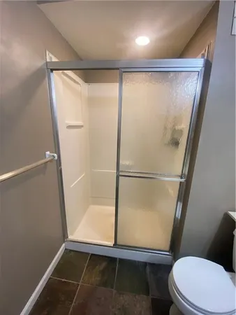 a living room with furniture gym equipment and windows