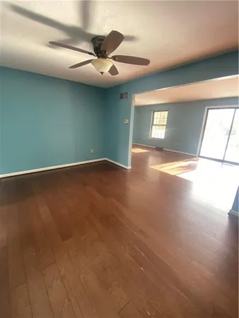 a view of a livingroom with a ceiling fan and window