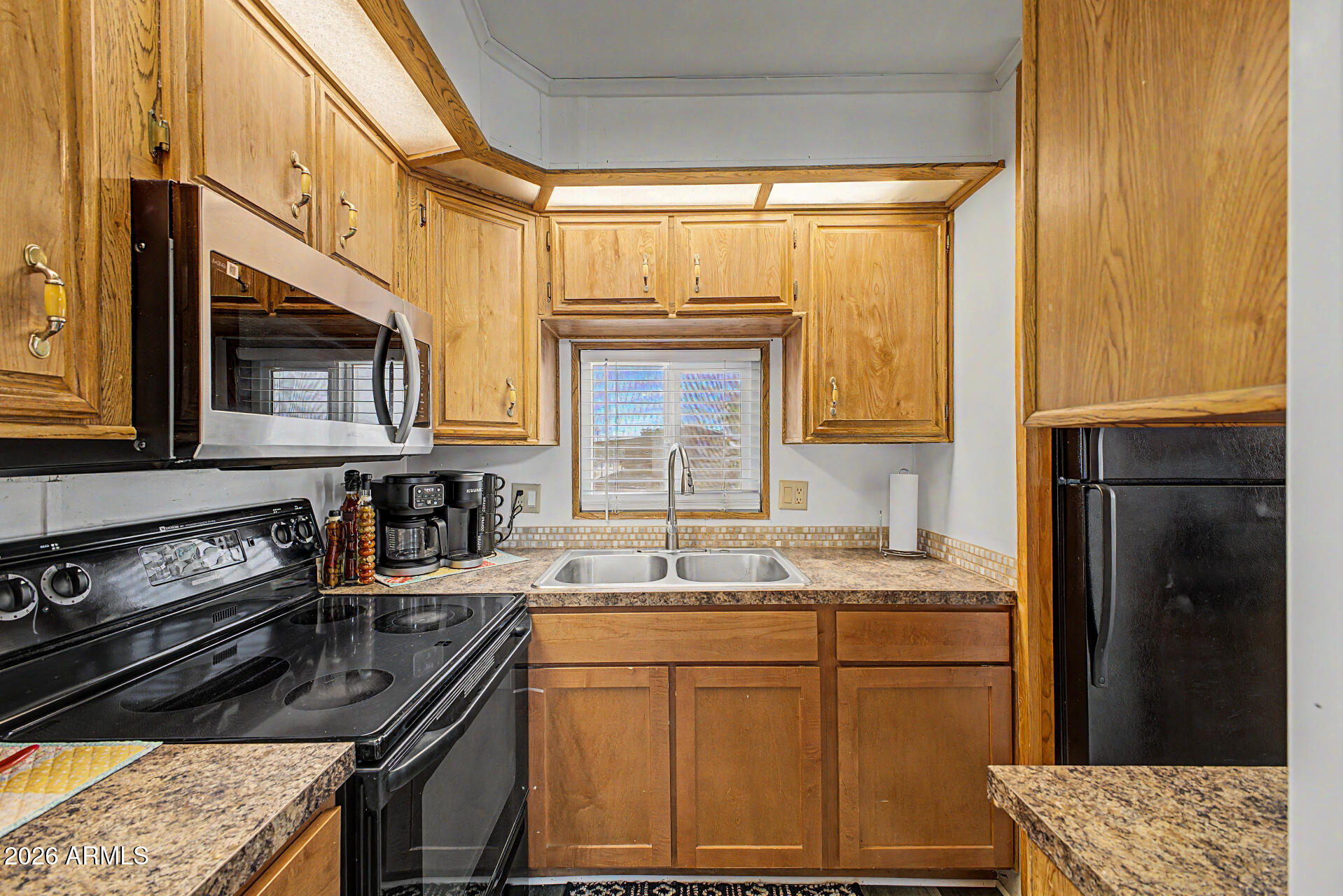 479 North Cactus Road Apache Junction, AZ 85119 - Photo 13 of 29 a kitchen with granite countertop a sink stove and refrigerator