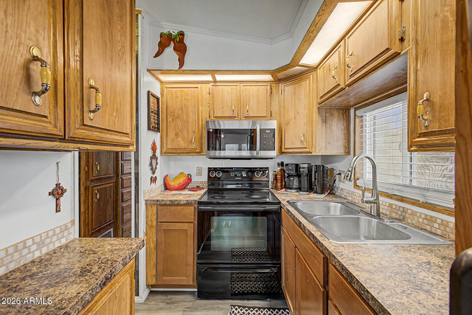 479 North Cactus Road Apache Junction, AZ 85119 - Photo 15 of 29 a kitchen with granite countertop a stove and a sink