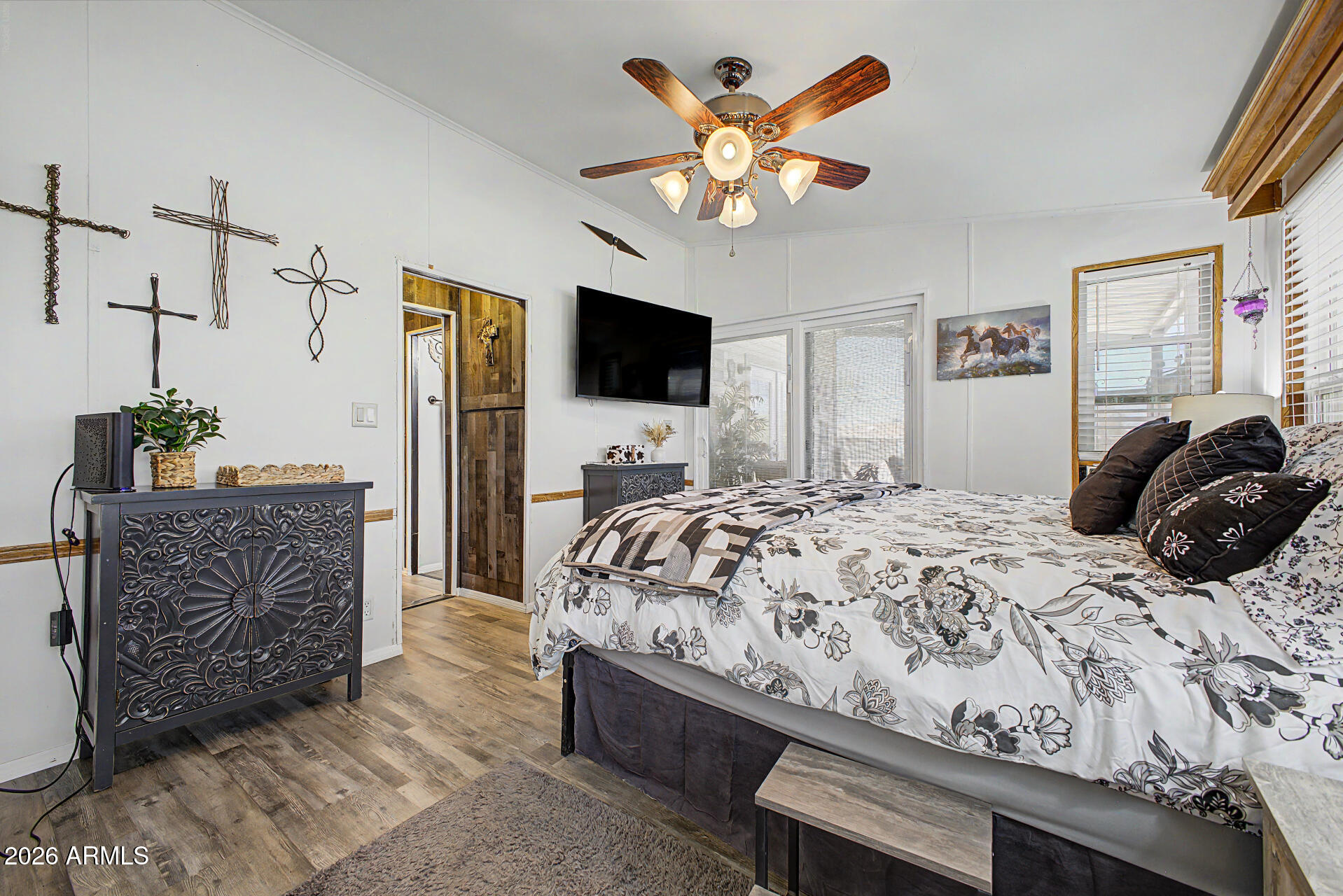 479 North Cactus Road Apache Junction, AZ 85119 - Photo 18 of 29 a bedroom with a bed chandelier flat screen tv and a window