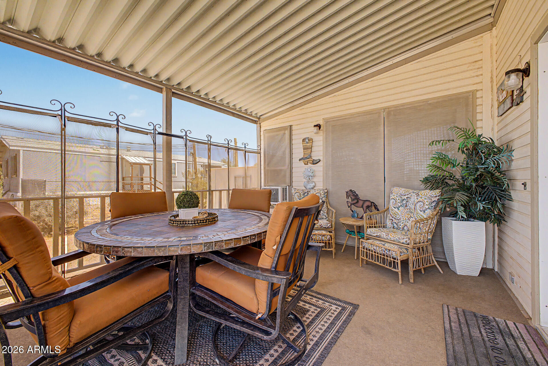 479 North Cactus Road Apache Junction, AZ 85119 - Photo 5 of 29 a view of a patio with a table and chairs and potted plants
