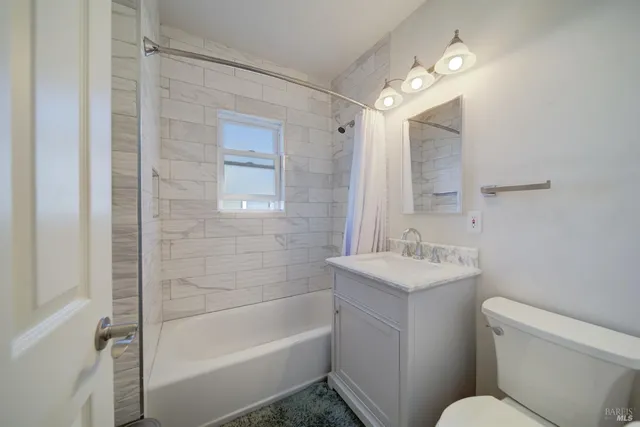a bathroom with a sink toilet vanity and bathtub