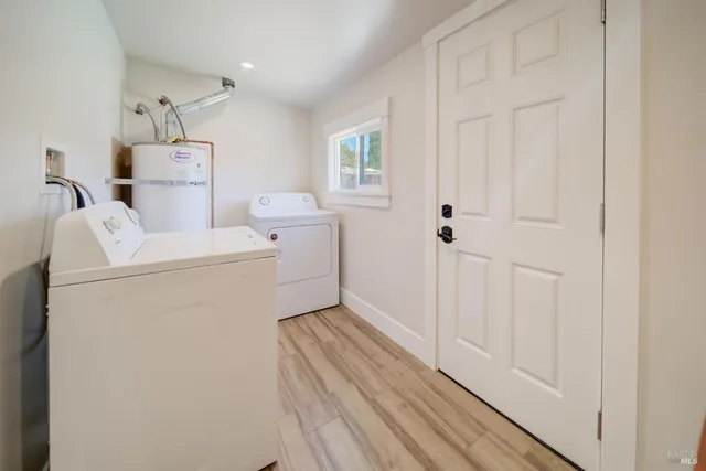 a view of storage and utility room with washer and dryer