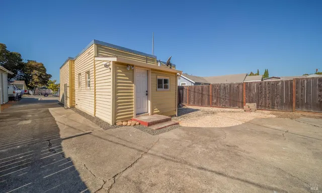 a view of backyard with a small cabin