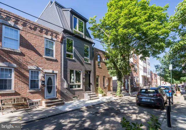 a front view of a house with a potted plant