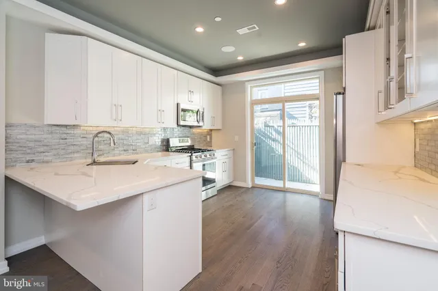 a kitchen with a sink a window and cabinets