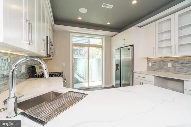 a kitchen with a refrigerator and a sink