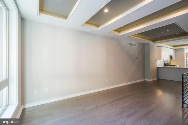 a view of a room with wooden floor and a window