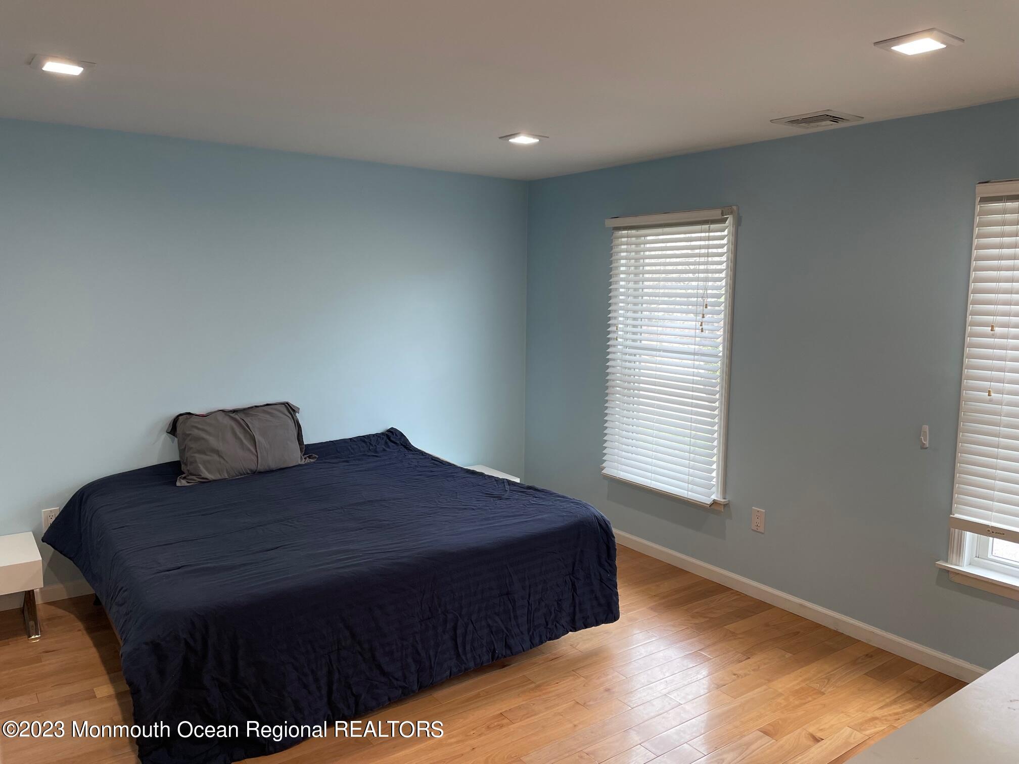 110 Poplar Avenue Deal, NJ 07723 - Photo 15 of 27 a large bed sitting in a bedroom next to a window
