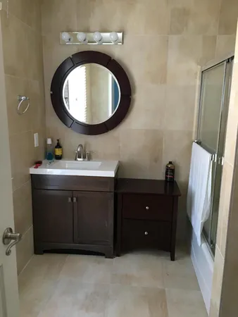 a bathroom with a sink vanity and a mirror