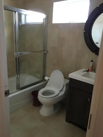a bathroom with a toilet a sink and shower
