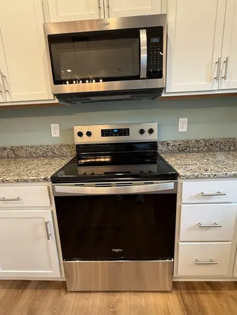 a stove top oven sitting inside of a kitchen