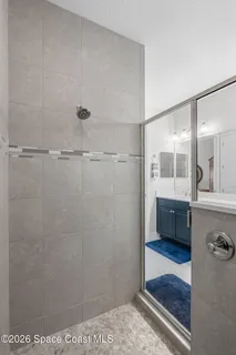 a bathroom with a glass shower door