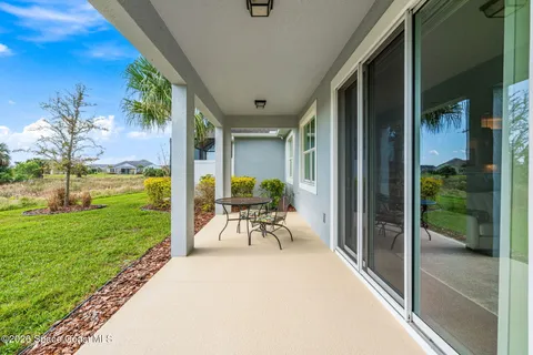 a view of a porch with furniture and garden