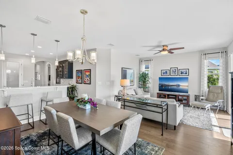a living room with furniture and kitchen view