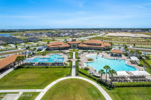 an aerial view of a house with a swimming pool