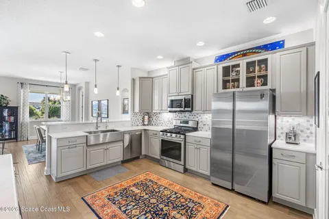 a modern kitchen with stainless steel appliances granite countertop a sink and stove