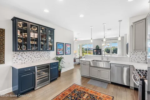 a large kitchen with stainless steel appliances kitchen island granite countertop a sink and cabinets