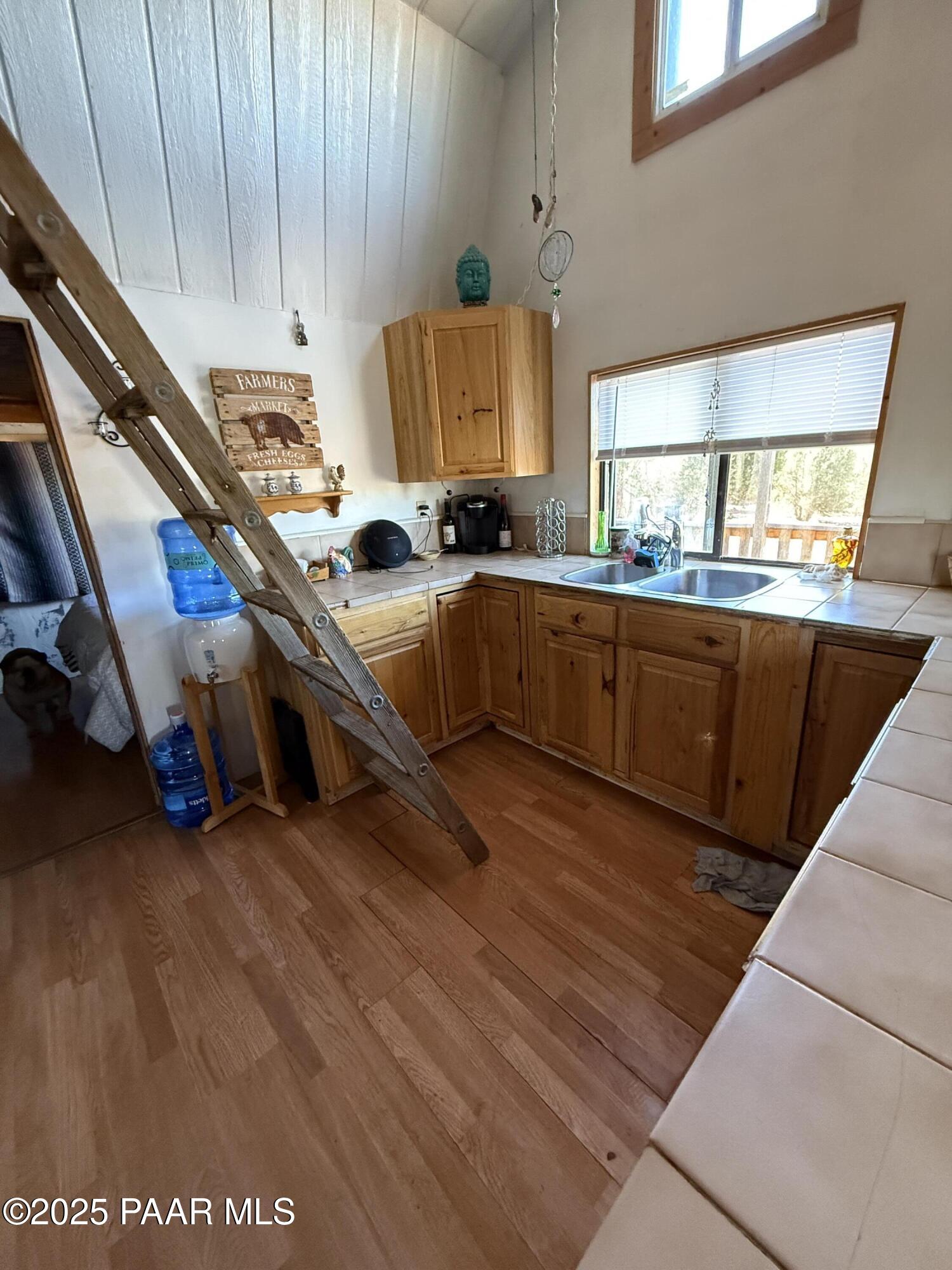 58350 Rana Road Seligman, AZ 86337 - Photo 5 of 18 a kitchen with stainless steel appliances granite countertop a sink a stove and a wooden floors