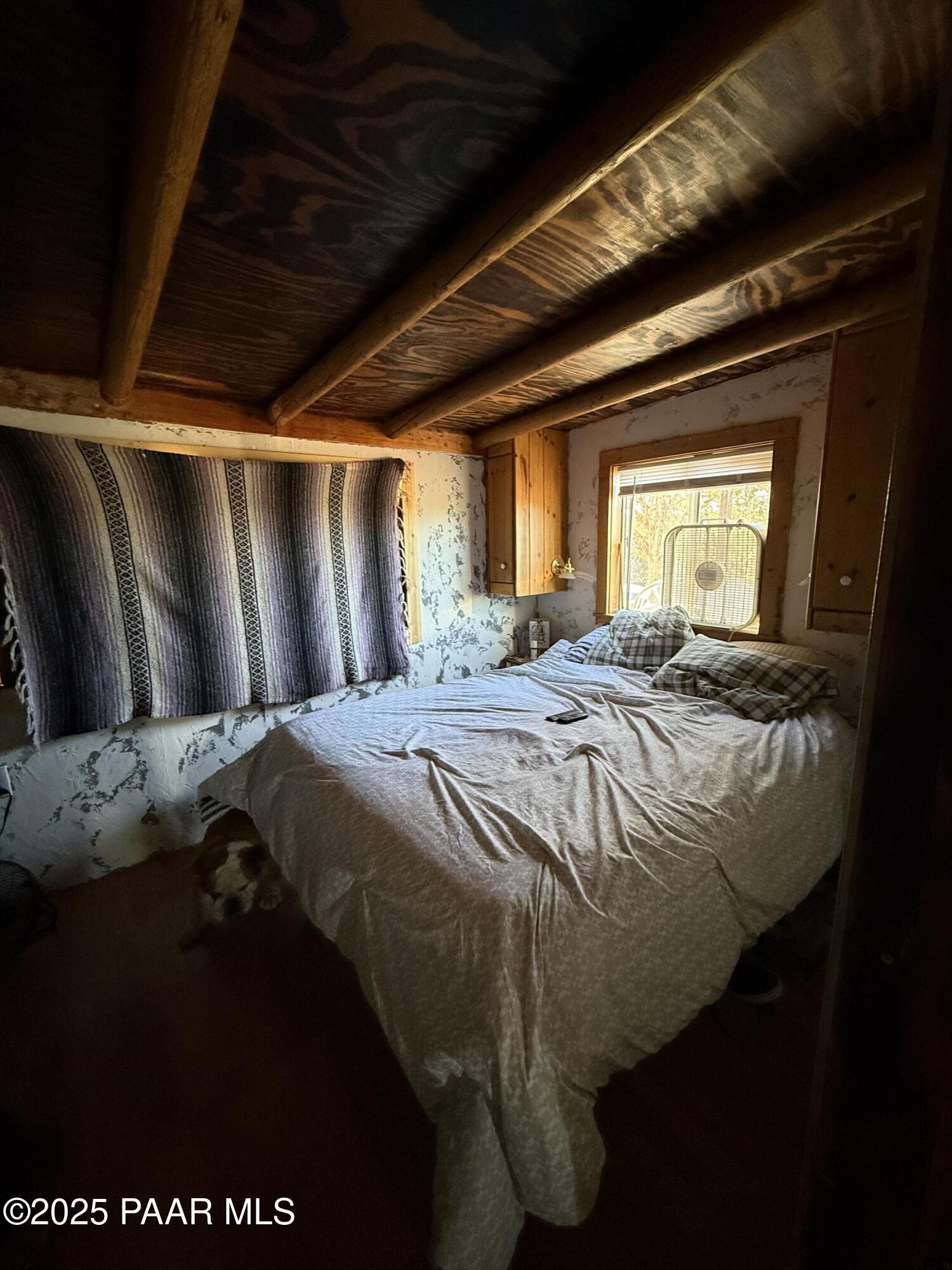 58350 Rana Road Seligman, AZ 86337 - Photo 6 of 18 a bed sitting in a bedroom next to a window