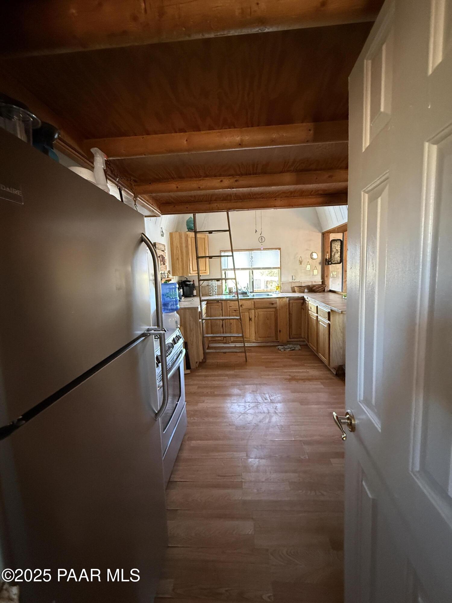 58350 Rana Road Seligman, AZ 86337 - Photo 8 of 18 a view of a refrigerator in kitchen and an empty room