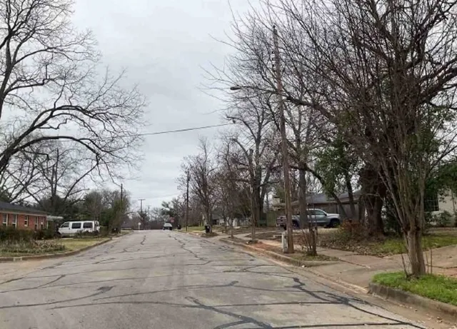 a wooden bench sitting in middle of a yard
