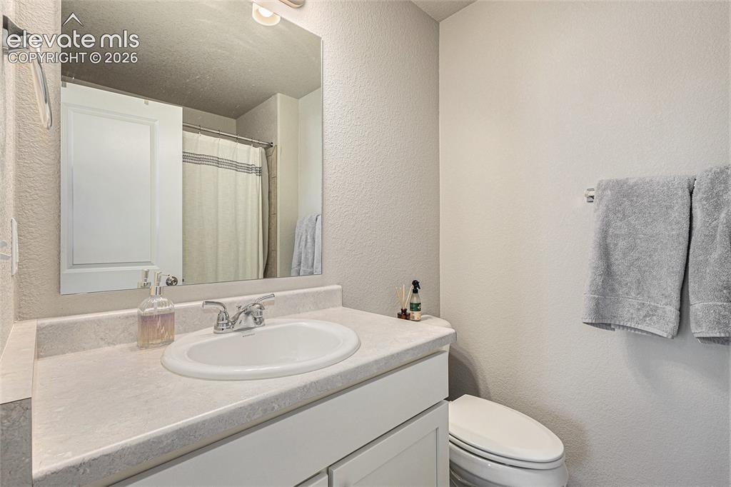 2940 Magic Carpet Loop Colorado Springs, CO 80916 - Photo 13 of 21 a bathroom with a sink toilet and shower