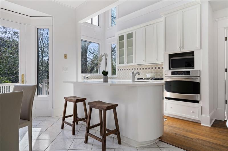 993 Highland View Northeast Atlanta, GA 30306 - Photo 11 of 54 a kitchen with kitchen island white cabinets and white appliances