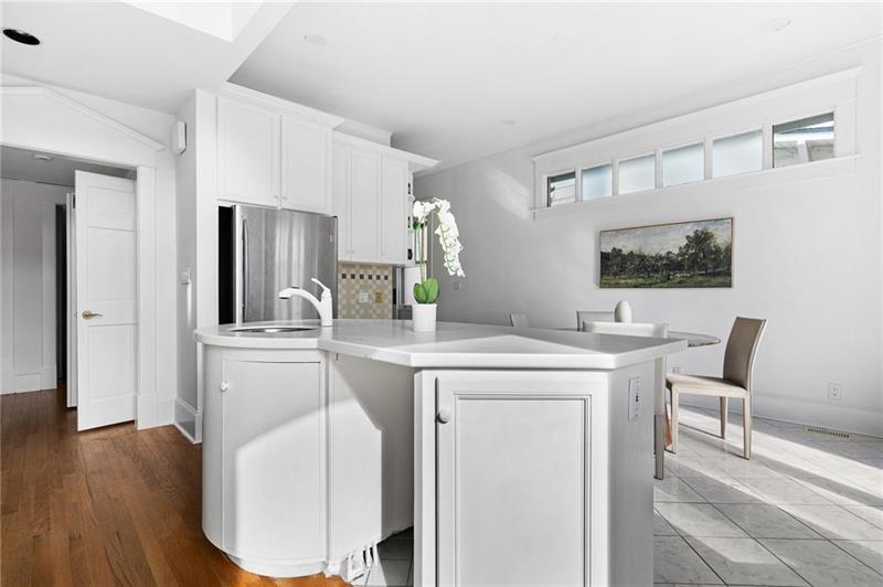 993 Highland View Northeast Atlanta, GA 30306 - Photo 12 of 54 a kitchen with kitchen island a stove a table and chairs in it