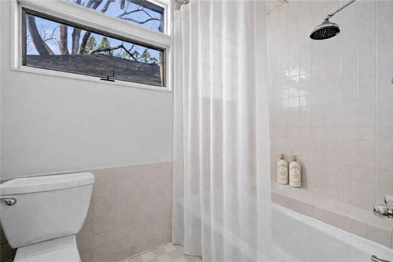 993 Highland View Northeast Atlanta, GA 30306 - Photo 19 of 54 a bathroom with a toilet and a shower curtain
