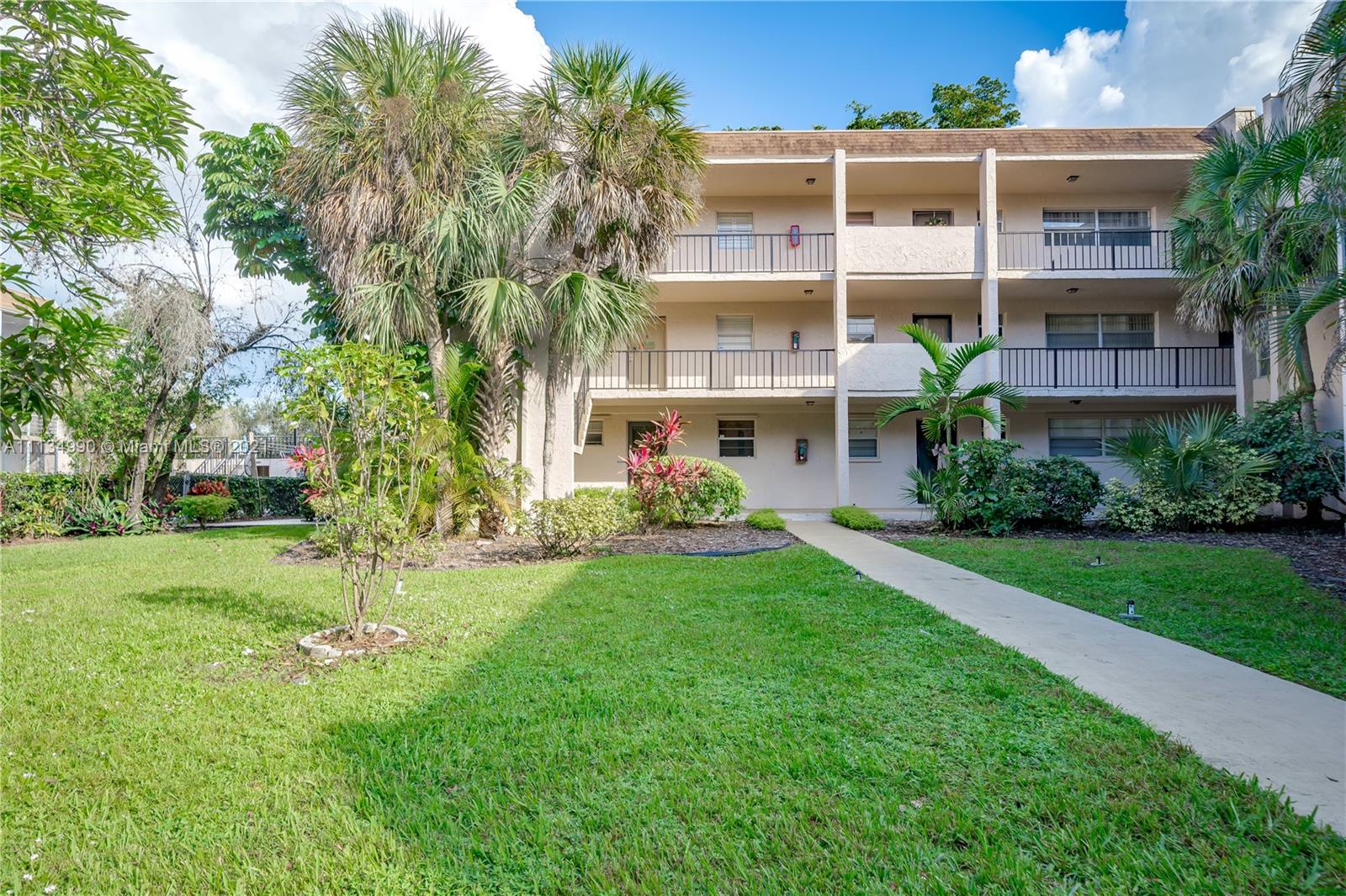 469 North Pine Island Road, Unit B305 Plantation, FL 33324 - Photo 2 of 38 a view of backyard with a garden and plants