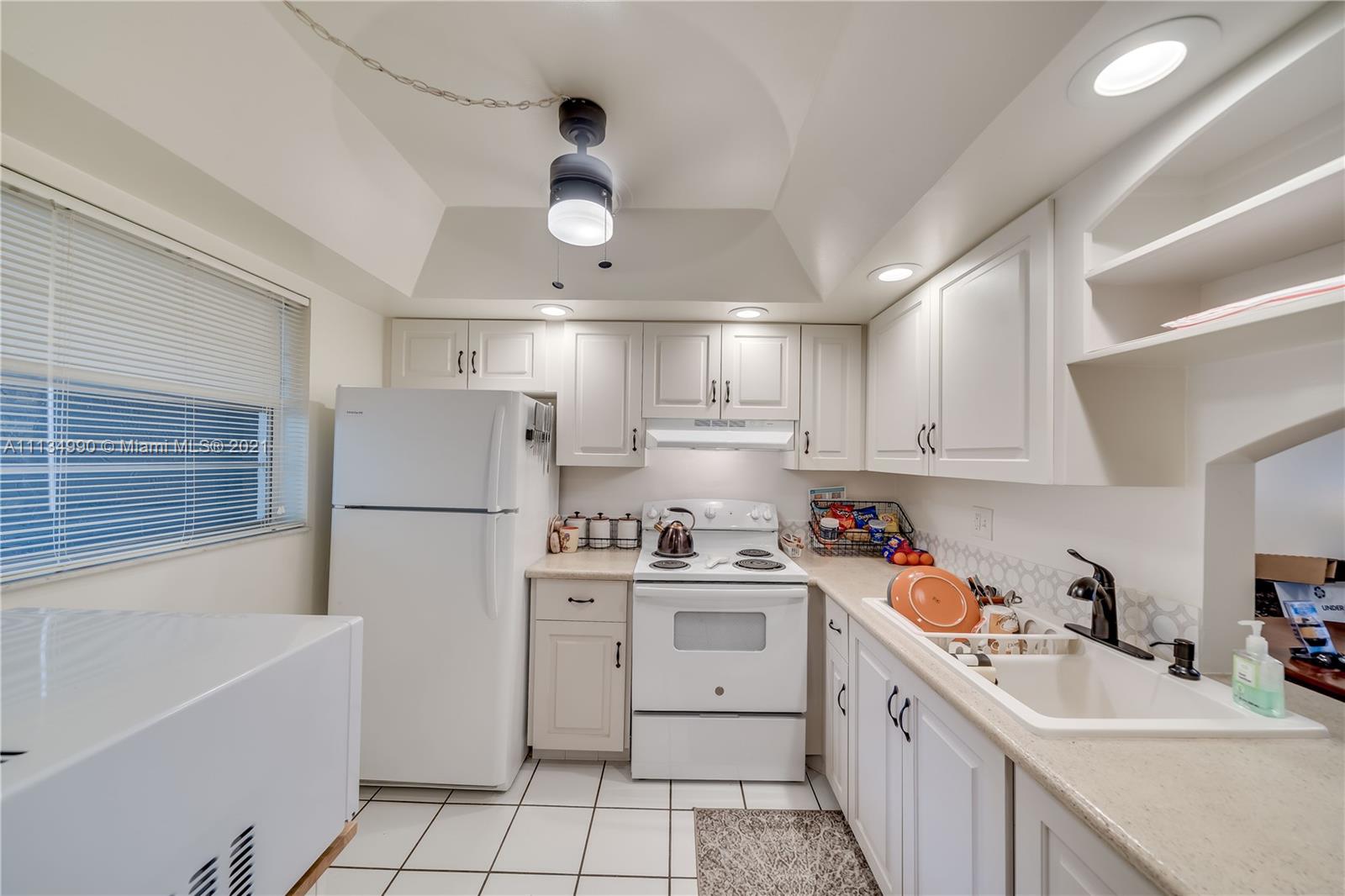 469 North Pine Island Road, Unit B305 Plantation, FL 33324 - Photo 11 of 38 a kitchen with a white cabinets and white appliances