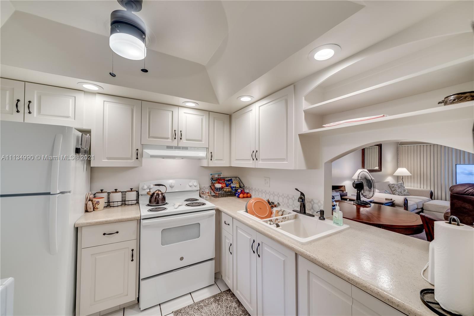 469 North Pine Island Road, Unit B305 Plantation, FL 33324 - Photo 12 of 38 a kitchen with white cabinets and white appliances