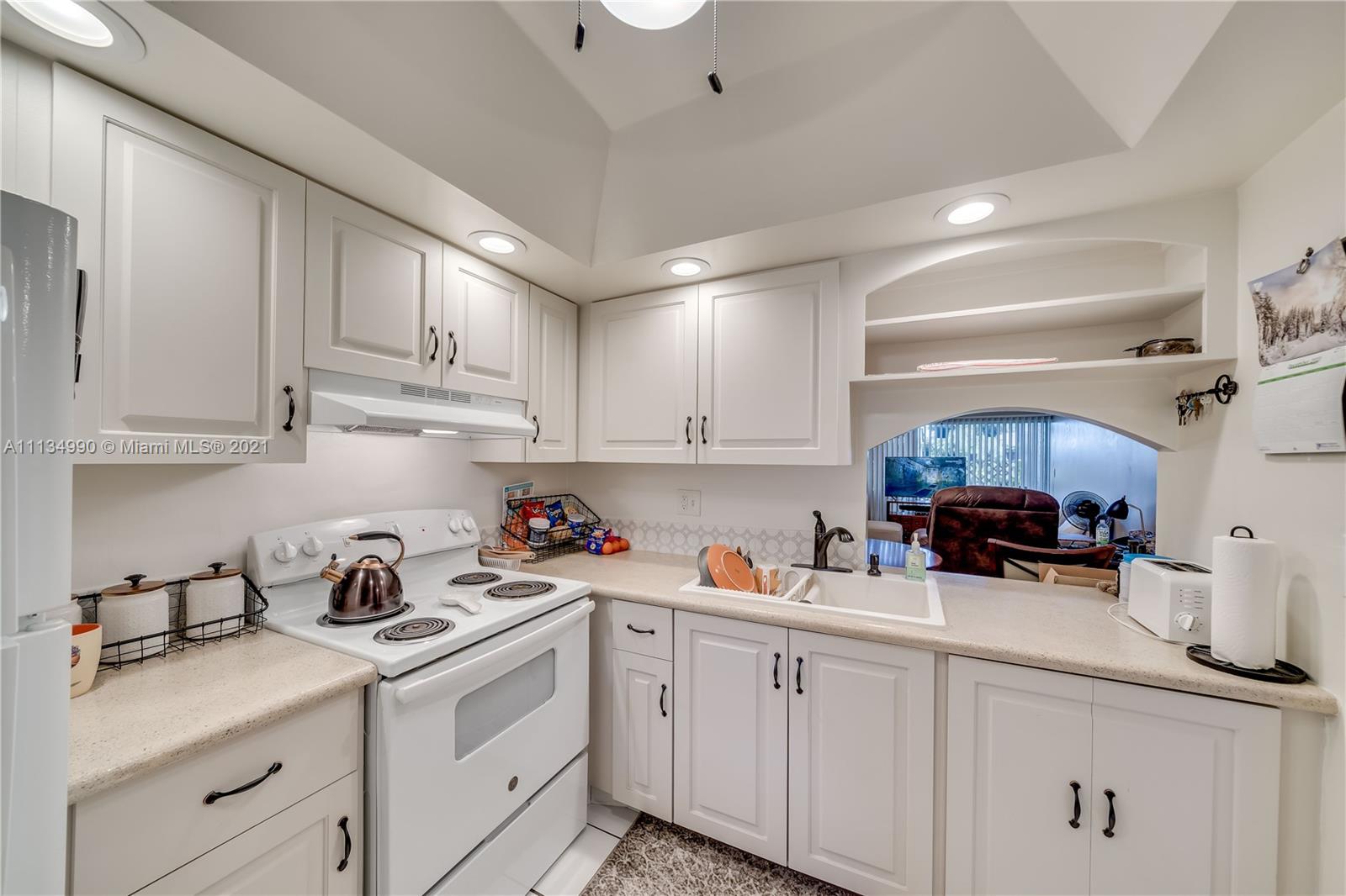 469 North Pine Island Road, Unit B305 Plantation, FL 33324 - Photo 15 of 38 a kitchen with cabinets a sink and appliances