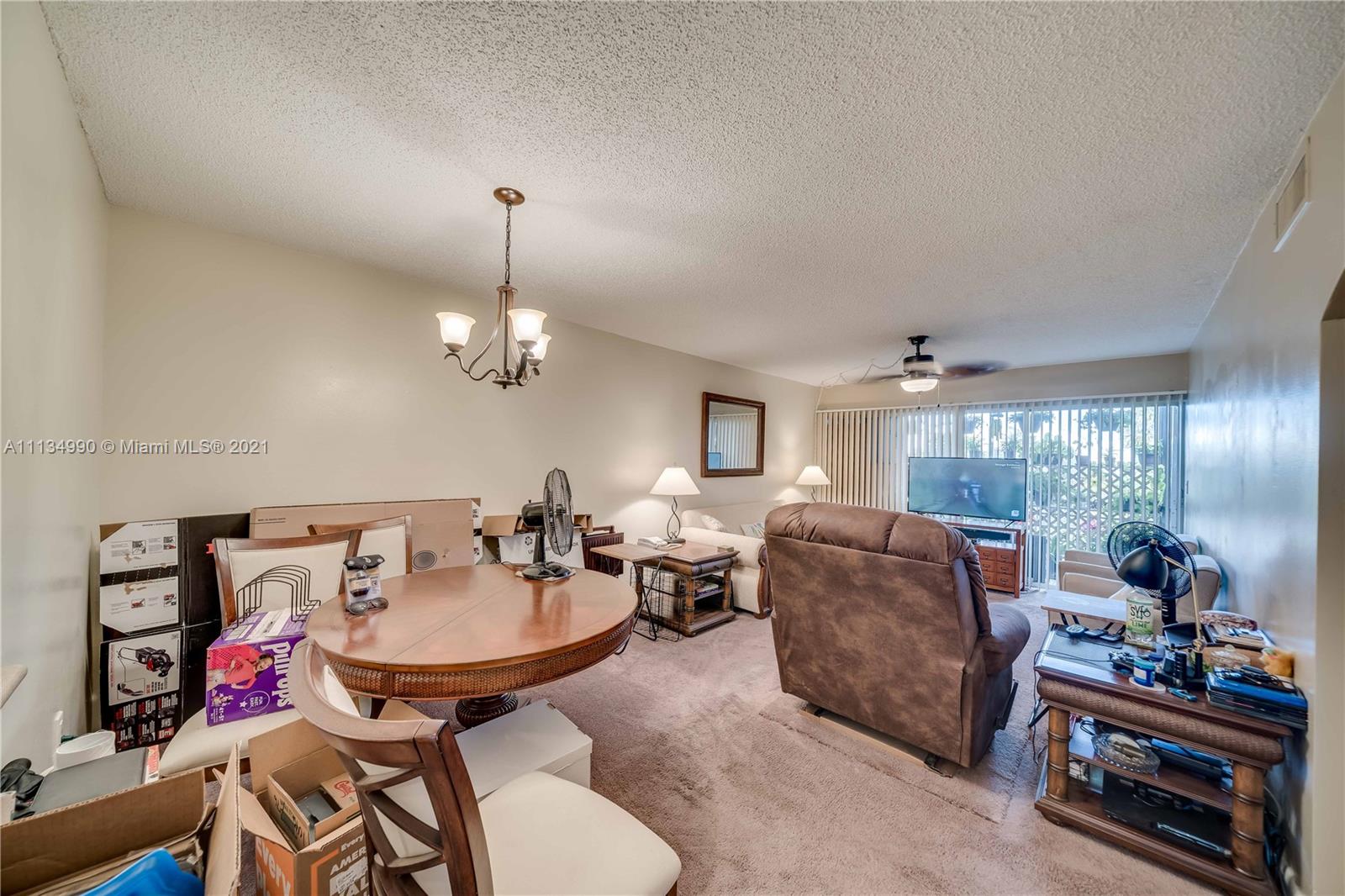 469 North Pine Island Road, Unit B305 Plantation, FL 33324 - Photo 16 of 38 a living room with furniture a window and gym equipment