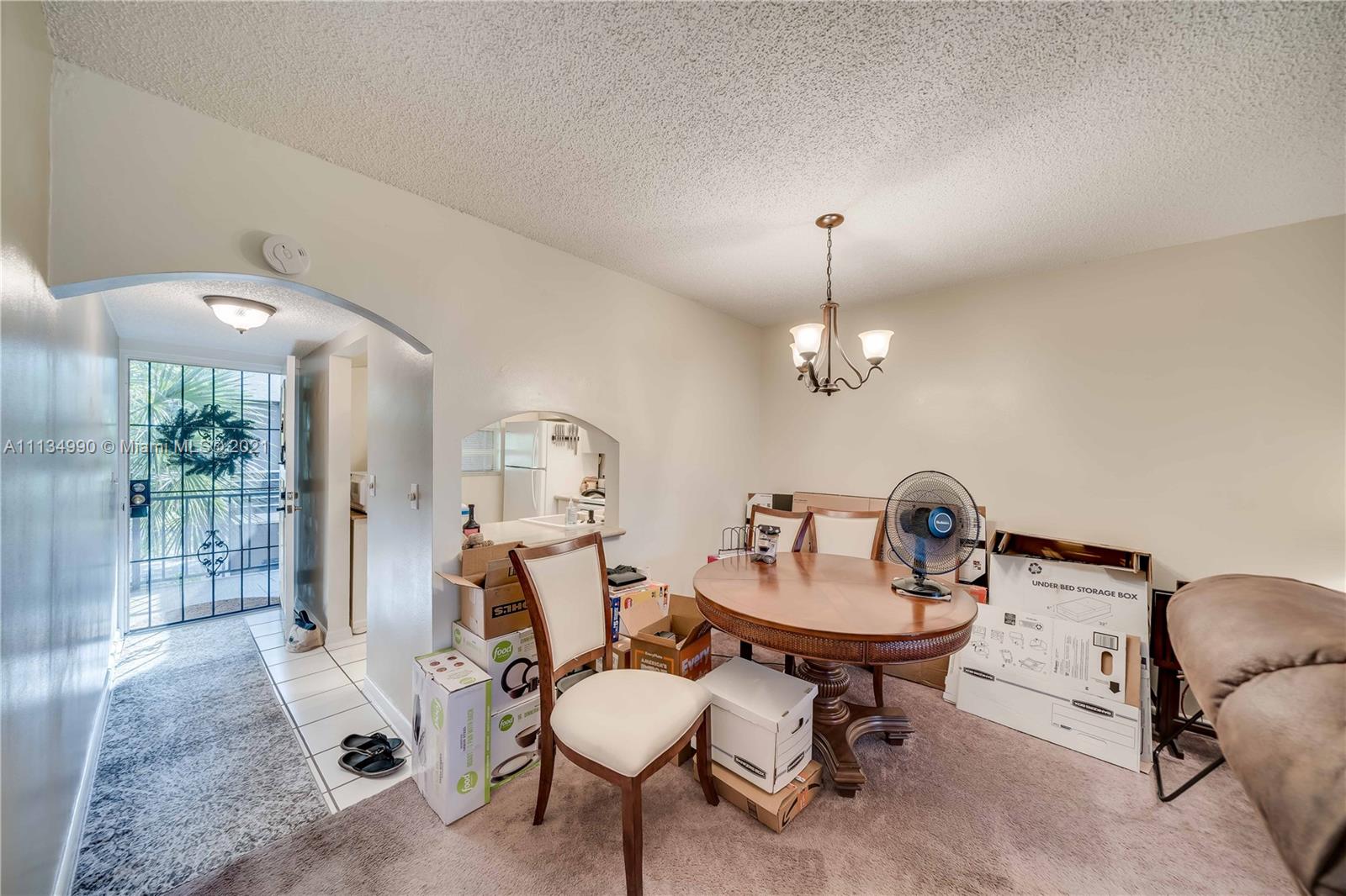 469 North Pine Island Road, Unit B305 Plantation, FL 33324 - Photo 17 of 38 a living room with furniture a window and a chandelier