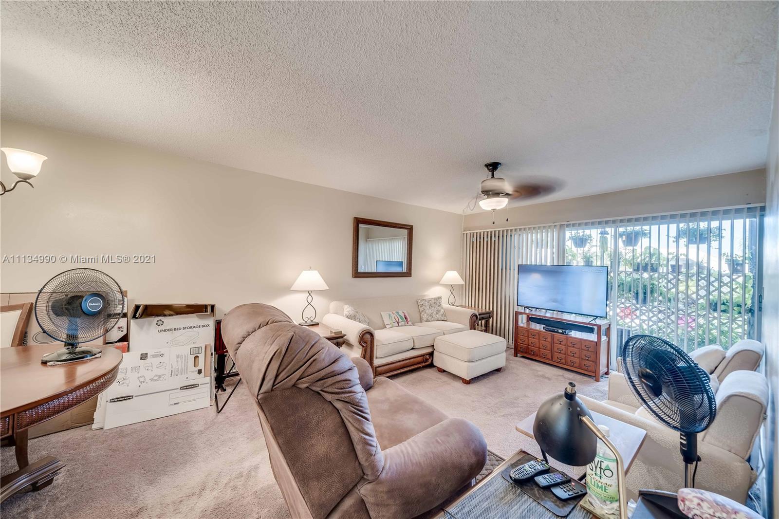 469 North Pine Island Road, Unit B305 Plantation, FL 33324 - Photo 18 of 38 a living room with furniture a large window and a fireplace
