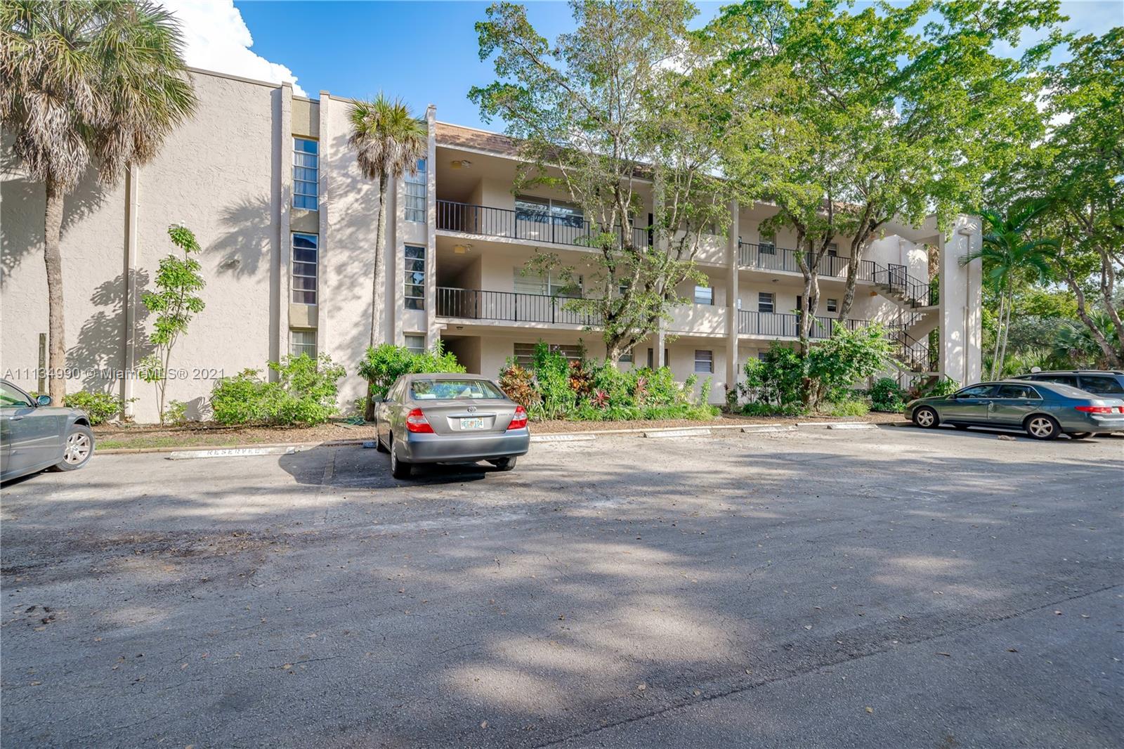 469 North Pine Island Road, Unit B305 Plantation, FL 33324 - Photo 3 of 38 a car parked in front of a building