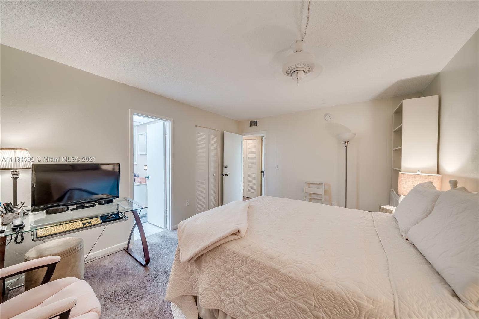 469 North Pine Island Road, Unit B305 Plantation, FL 33324 - Photo 25 of 38 a bedroom with a bed and a flat screen tv