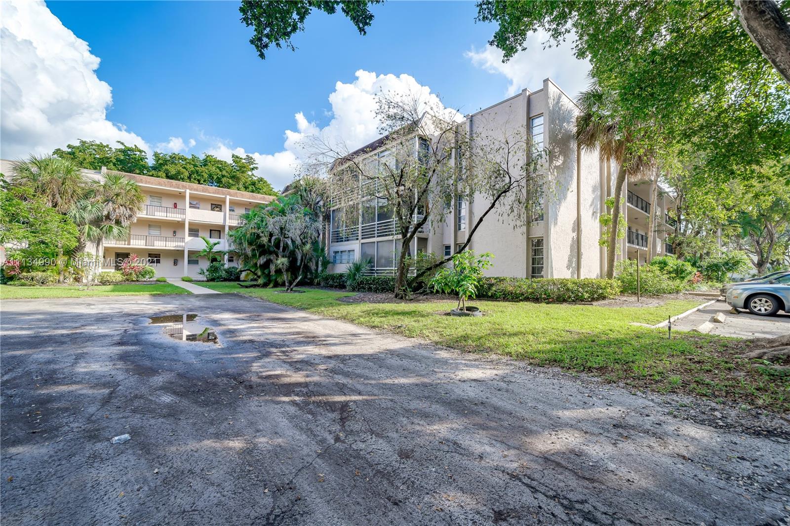 469 North Pine Island Road, Unit B305 Plantation, FL 33324 - Photo 4 of 38 a view of a house with a big yard plants and large trees