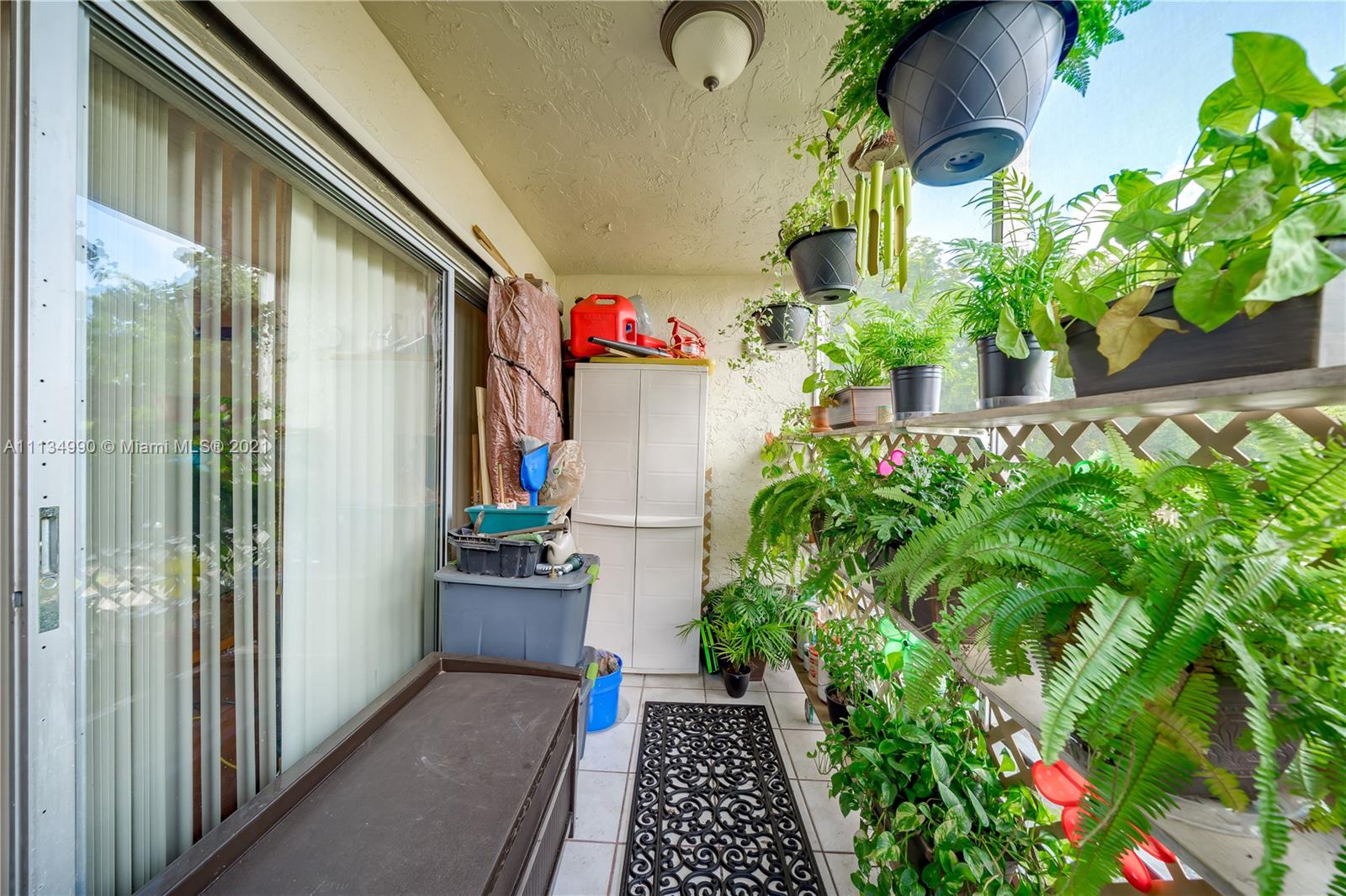 469 North Pine Island Road, Unit B305 Plantation, FL 33324 - Photo 33 of 38 a potted plant sitting in front of a door
