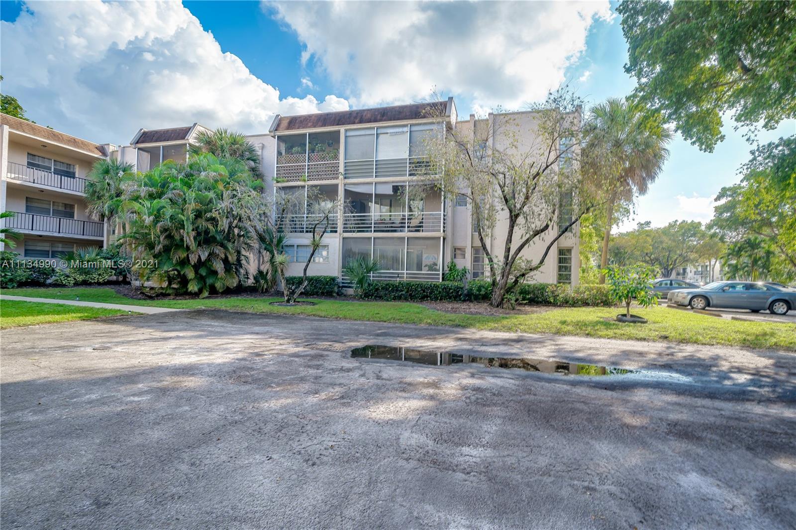 469 North Pine Island Road, Unit B305 Plantation, FL 33324 - Photo 5 of 38 a view of a building with a yard