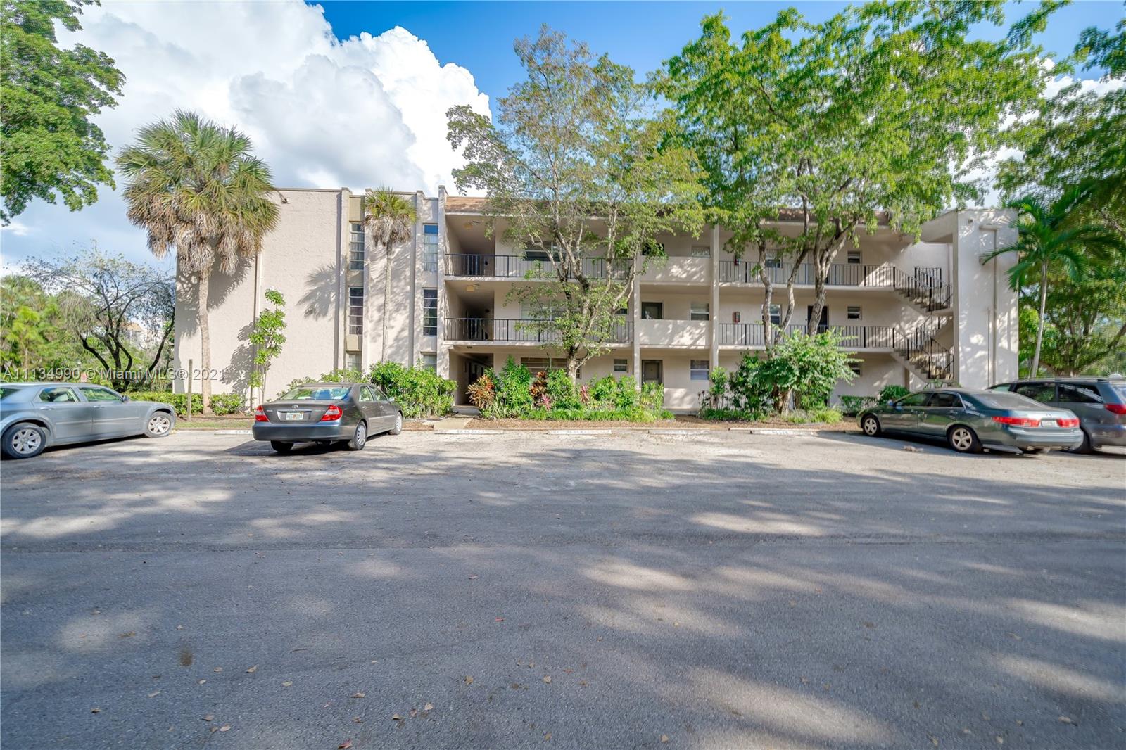469 North Pine Island Road, Unit B305 Plantation, FL 33324 - Photo 6 of 38 a view of road with card parked on side and road