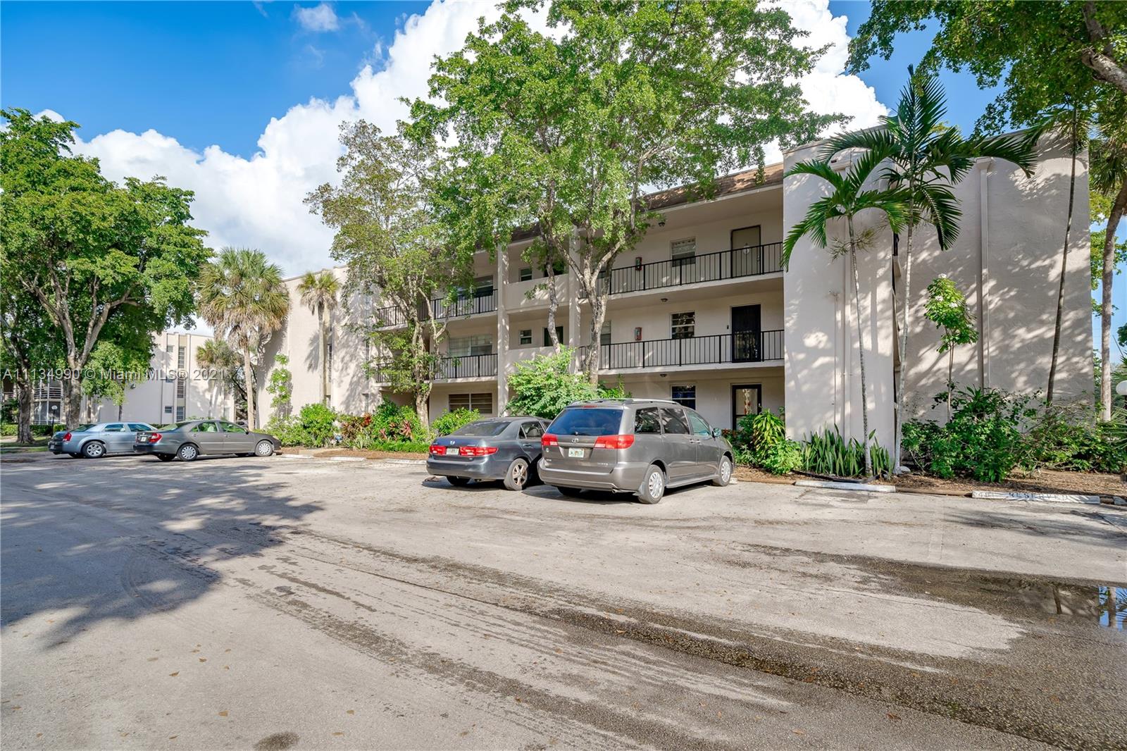 469 North Pine Island Road, Unit B305 Plantation, FL 33324 - Photo 7 of 38 a view of road with card parked on side of road