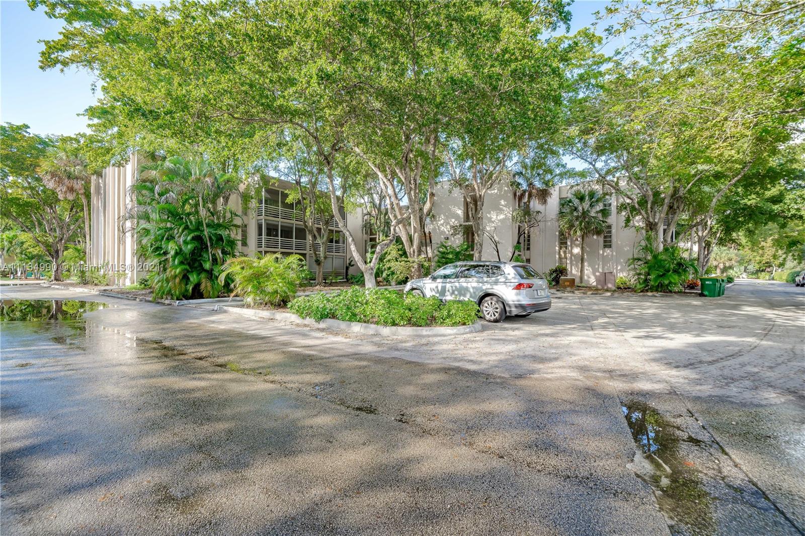 469 North Pine Island Road, Unit B305 Plantation, FL 33324 - Photo 8 of 38 a car parked on the side of a road