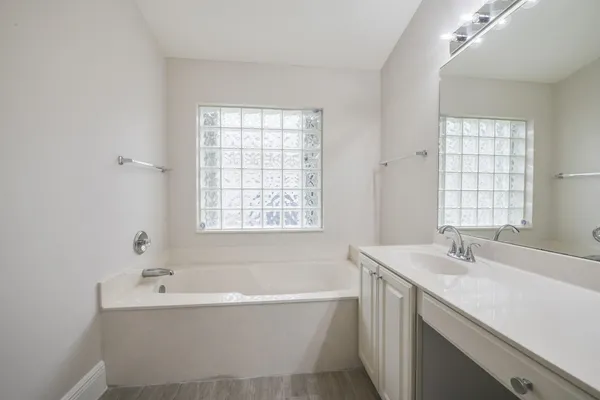 a bathroom with a bathtub and a sink