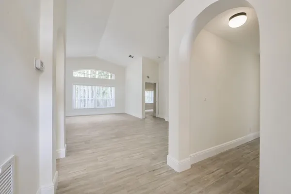 an empty room with windows and entrance